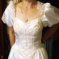 a woman in a wedding dress is posing for the camera