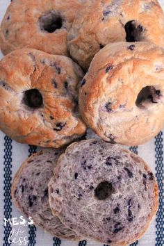 four blueberry bagels stacked on top of each other