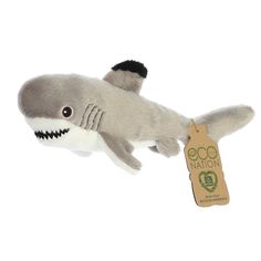 a stuffed shark with a tag in its mouth