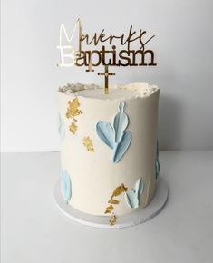 a white cake with blue and gold leaves on it