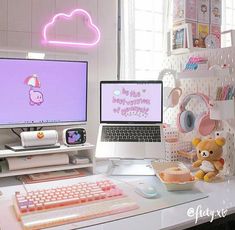 two computer monitors sitting on top of a desk next to a keyboard and mouse with a teddy bear