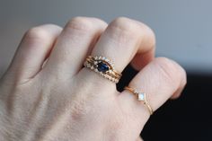 "Loving this beautiful Blue Sapphire. This ring is perfect as a gift, something blue, or as an engagement ring for the girl that wants something different. - 6x4mm Blue Sapphire center stone - 1.3mm side diamonds (.02 Ct total) - 1.3mm round band - Available in 14K yellow, white or rose gold Pairs perfectly with our seven diamond \"Crown\" wedding band! Click here: https://www.etsy.com/listing/555115894/14k-gold-diamond-curved-wedding-band?ref=shop_home_active_1 Processing Times - Current proces Elegant Round Cut Blue Stackable Rings, Blue Oval Stackable Rings For Anniversary, Delicate Blue Anniversary Rings, Oval Sapphire Stackable Rings For Gift, Oval Sapphire Stackable Rings As A Gift, Blue Oval Stackable Promise Rings, Blue Oval Stackable Rings As Gift, Blue Oval Stackable Rings For Gift, Dainty Blue Oval Rings