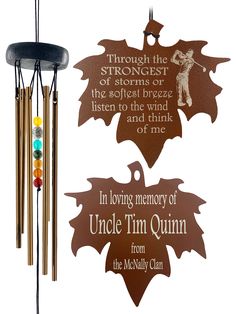 a wind chime with an oak leaf design and quote on it's side