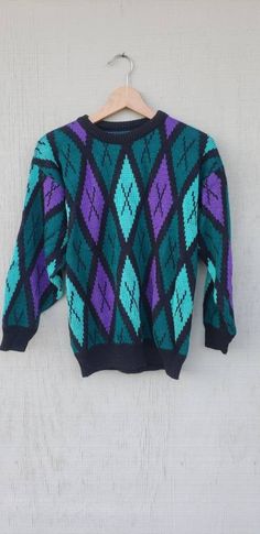 "Loving this rad sweater featuring a diamond green & purple colorblock design,  relaxed fit! Looks suuuper cute paired with leggings & your fave kicks! Great Vintage condition. Vintage circa 1990. Details: * Great Vintage condition * Vintage circa 90s  * Soft Fabric (unsure of fabric)  * Length from front: 22\" * Length from back: 24\" * Bust: 19\" * Sleeve from Shoulder: 18\"" 90s Style Purple Sweater For Fall, 90s Style Purple Fall Sweater, 90s Purple Winter Sweater, Retro Purple Sweater For Winter, Retro Purple Winter Sweater, 90s Green Winter Sweater, Green 90s Style Winter Sweater, Green 90s Winter Sweater, Purple Fits