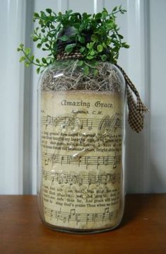 a jar with some plants in it on a table