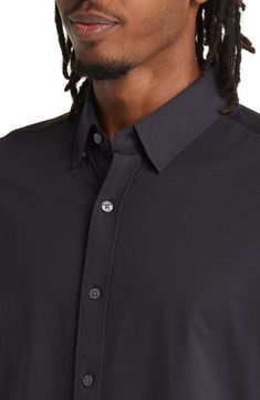 Great for going out or to the office, this button-up shirt is made from an ultracomfortable stretch material and is cut in a modern slim fit. 28" length; 42" chest (size Medium) Front button closure Button-down collar Long sleeves with button cuffs 86% polyamide, 14% elastane Machine wash, tumble dry Imported Classic Black Stretch Shirt, Sleek Black Business Shirt, Modern Business Casual Shirt With Button Closure, Sleek Fitted Shirt With Buttons, Sleek Button-up Business Tops, Stretch Button-up Tops For Business, Casual Shirt With 4-way Stretch For Workwear, Modern Button-up Dress Shirt, Modern Business Casual Shirt With Placket