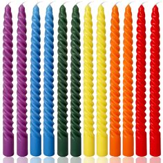 many different colored candles are lined up in the same row on a white background photo