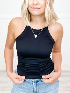 Amp up your casual style with our High Neck Ribbed Tank Top! Perfect for layering or on its own, this tank features a trendy high-neck design and ribbed texture for added interest. Versatile and comfortable, this top is a must-have for any wardrobe! Fabric: 92% Nylon / 8% Spandex Trendy Ribbed Turtleneck Tank Top, Black High Neck Tank Top For Layering, Chic Black Tank Top With Ribbed Neckline, Black Turtleneck Tank Top For Spring, Solid Ribbed Halter Neck Top, Chic Solid Ribbed Tank Top, Chic Ribbed Solid Color Tank Top, Trendy Ribbed Racerback Tank Top, Trendy Solid Color Tank Top With Ribbed Neckline