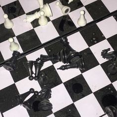 black and white chess pieces on a checkered board