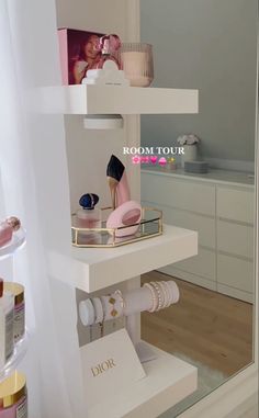 there is a white shelf with cosmetics and other items on it in front of a mirror