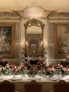 an elaborately decorated dining room with floral centerpieces