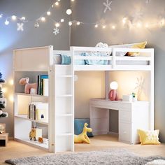 a white loft bed with stairs and desk in a child's room decorated for christmas