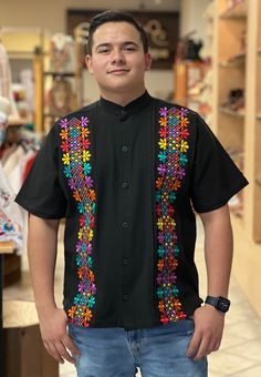 This beautiful Traditional Guayabera for Men is embroidered with a colorful Ethnic design and adds a sophisticated flare to your wardrobe.  This elegant button up Shirt is perfect for special occasions such as Mexican Fiestas, Quinceañeras, Weddings, etc. This guayabera is made by Mexican Artisans in Guanajuato, Mexico. More styles available here: https://www.etsy.com/es/shop/SoleiEthnic?ref=seller-platform-mcnav&section_id=26873542 Traditional Black Embroidered Shirt, Traditional Black Shirt With Floral Embroidery, Traditional Short Sleeve Shirt With Multicolor Embroidery, Traditional Shirt With Multicolor Embroidery, Traditional Fit Embroidered Shirt, Multicolor Embroidered Short Sleeve Shirt, Traditional Shirt With Multicolor Embroidery For Summer, Traditional Multicolor Embroidered Shirt For Summer, Traditional Shirt With Multicolor Floral Embroidery