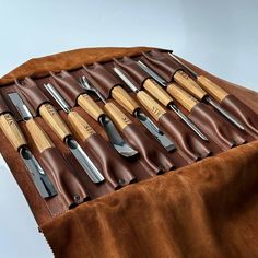 a leather case with knives and spoons in it