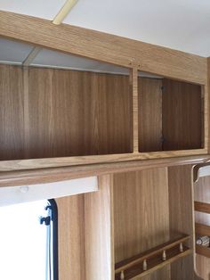 the inside of a wooden rv with shelves