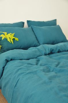 a bed with blue sheets and yellow flowers on it