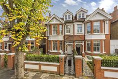 this is an image of a large house with many windows and bushes on the front