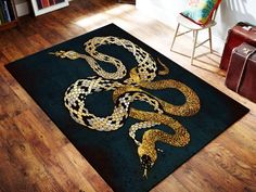 a rug with a snake on it in the middle of a room next to a chair