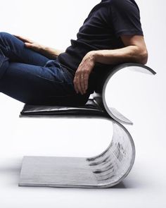 a man sitting on top of a black chair