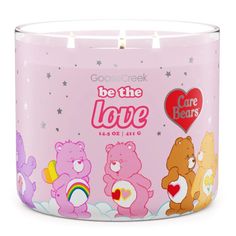 a pink candle with bears on it and the words be the love written in red