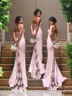 three beautiful women in pink dresses standing on steps with their backs turned to the camera