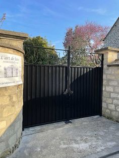 an iron gate in front of a stone building with a sign on it that says l'art de paris