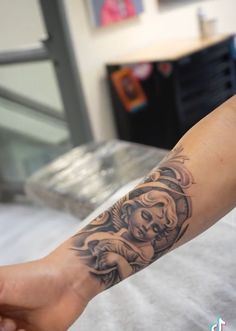 a person's arm with a tattoo on it and a skull in the middle