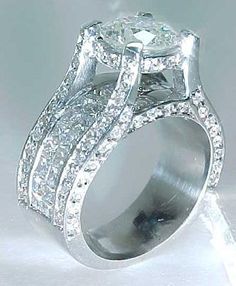 an engagement ring with three rows of diamonds on it