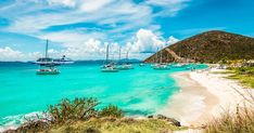 several boats floating in the ocean on a sunny day with blue sky and white clouds