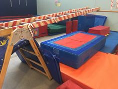 an indoor trampoline course with ladders and obstacles for children to play on