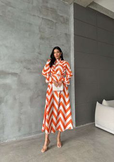 Feel effortlessly stylish and comfortable in our Striped Long Maxi Dress with Ruffles. Perfect for summer days, this dress is designed for those who want to enjoy the season while staying modest and chic. Made from lightweight cotton, this abaya-inspired dress is vacation-ready and will keep you cool all day long. Product Features: - Maxi length for a stylish and modest look. - Ruffle details add a feminine touch. - Made from breathable cotton to keep you comfortable in hot weather. - Perfect for summer vacations and beach days. - Easy to style for day or night looks. - Available in a variety of colors and stripe patterns. - Versatile dress that can be dressed up or down. - Flattering silhouette for all body types. Evening Jumpsuit, Summer Vacations, Dress With Ruffles, Maxi Dress Formal, Versatile Dresses, Night Looks, Inspired Dress, Beach Days, Long Maxi