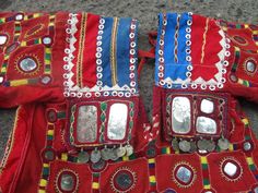 two pieces of red cloth covered in silver coins