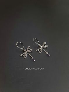 Beautiful silver dragonfly earrings with amethyst beads. Very detailed silver dragonflies are on handmade stainless steel ear hooks. Total earring length is just under 2 inches.  *Silver plated brass dragonflies  *Stainless steel ear hooks *Faceted amethyst beads  *Handmade with love <3 Like Jmesjewelrybox on Facebook for updates on new jewelry, upcoming sales and giveaways! Plus Facebook fans save 5% :D Find the coupon code on Jmesjewelrybox's cover photo https://www.facebook.com/Jmesjewelrybox Elegant Sterling Silver Dragonfly Earrings, Handmade Purple Sterling Silver Earrings, Handmade Purple Metal Earrings, Purple Metal Earrings As Gift, Purple Metal Earrings For Gift, Sterling Silver Dragonfly Earrings, Silver Sterling Dragonfly Earrings, Dainty Sterling Silver Dragonfly Jewelry, Elegant Adjustable Dragonfly Jewelry