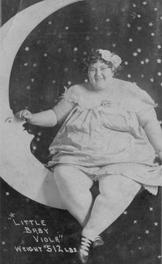 an old black and white photo of a woman sitting on the moon