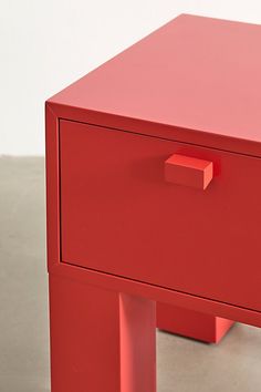 a red table with two drawers on each side