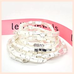 Lovely rectangular and square beads create an opulent look when the bracelets are worn together, and something more casual when the wealth is spread to both wrists. The set consists of seven bracelets—enough for anyone to build a solid foundation of style. With its gorgeous brick-like features, this antiquated-silver stackable stretch bracelet is chock full of class. Each bracelet is slightly stretchy to fit most wrists. Materials: Sterling silver plated pewter Each bracelet is about 6.5" long M Elegant Adjustable Stacked Beaded Bracelets, Party Bracelets With Rectangular Links, Elegant Silver Square Bracelet, Modern White Rectangular Bracelet, Silver Rectangular Beaded Bracelets As Gift, Rectangular Silver Beaded Bracelets As Gift, Elegant Adjustable Rectangular Beaded Bracelets, Elegant Square Adjustable Bracelets, Square Beads