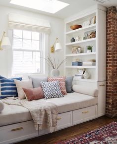 a living room filled with lots of white furniture