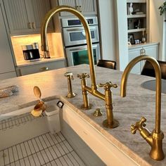 two faucets are on the kitchen counter top