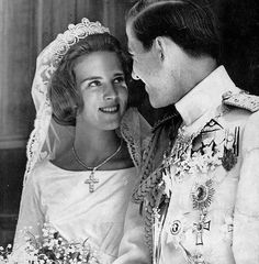 an old black and white photo of a man in uniform with a woman on her wedding day