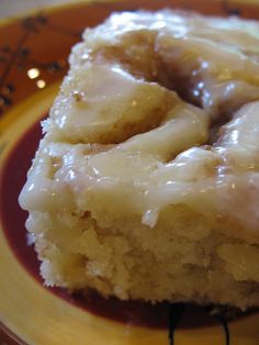 two glazed donuts sitting on top of a yellow plate