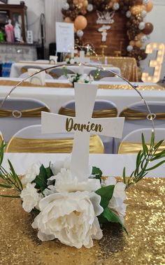 white flowers and greenery sit on the table at a wedding reception with gold sequins