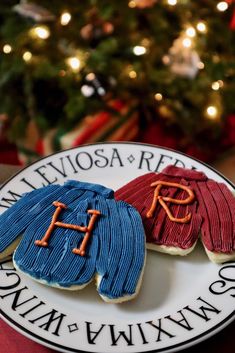 three decorated cookies sitting on top of a white plate