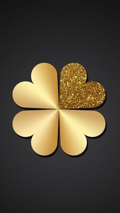 a gold shamrock with two hearts on it