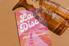 a pink and white party card with a bottle of eau - rive on it