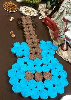 cupcakes are arranged in the shape of a train on top of a table