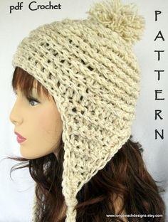 a crocheted hat with a pom - pom on the top is shown