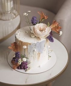 a white cake decorated with flowers on a table