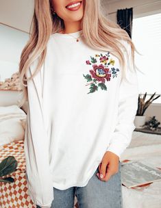 FLORAL BLOOM Long Sleeve T-shirt with Whimsical floral design on the left side, Boho Flower Shirt, Nature Lover gift, Summer Flower Shirt, Peony Tee, Garden Lover Shirt, Gift for Wife, Mother's Day Gift  If you're looking for cool designs on shirts and outstanding premium quality this is the right place. Our t-shirts made of soft lightweight jersey, they are stylish shirts, stretchy, flattering all over, very cute and comfortable. You can combine them with jeans, pants and various jackets for different styles. The styling possibilities are endless.. Roll up the sleeves, tie a side knot, front tuck, or wear it while lounging around the house.. We guarantee that you will love the fit, and the softness of this shirts, they are so nice to the body and gives comfy feeling. Make sure to attach E White Crew Neck Top With Floral Embroidery, Chic Long Sleeve Shirt With Floral Embroidery, White Floral Embroidery Sweatshirt For Spring, White Floral Print Long Sleeve Tops, Casual White Sweatshirt With Floral Embroidery, White Floral Print Crew Neck Shirt, White Floral Embroidery Relaxed Fit Top, White Floral Embroidery Sweatshirt With Relaxed Fit, White Floral Print Crew Neck Top