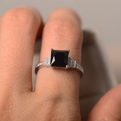 Classic Black Spinel Sapphire Ring For Anniversary, Classic Black Sapphire Ring In Sterling Silver, Gift Black Diamond Sterling Silver Ring, Elegant Black Spinel Diamond Ring As Gift, Black Sapphire Ring In Sterling Silver For Formal Occasions, Black Rings With Rectangular Stone For Anniversary, Black Rectangular Stone Ring For Anniversary, Elegant Square-cut Sapphire Ring In Sterling Silver, Elegant Black Spinel Sapphire Promise Ring