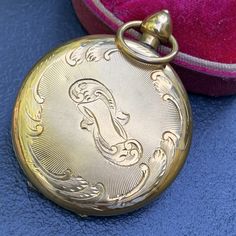 Antique Georgian /Victorian ~ Locket opens to reveal a compartment which hold an old Daguerreotype photo and hair lock on other side with glass cover and fitters ring ~ Front has hand engraved village scene and back has scroll design .. Unsigned /unmarked gold ( acid tested gold for atleast 14kt solid gold , likely 15k for the age of it ) ~ Top bail tests for 10kt gold which gives more strength and is original to locket . Measures : 2 inches in total drop length (top bail included ) x 1 1/2 inch Classic Medallion Pocket Watch For Wedding, Antique Gold Pocket Watch With Locket For Formal Occasions, Formal Antique Gold Pocket Watch With Locket, Antique Gold Locket Pocket Watch For Formal Occasions, Vintage Medallion Pocket Watch For Wedding, Vintage Medallion Pocket Watch For Weddings, Vintage Engraved Pocket Watch For Formal Occasions, Antique Engraved Pocket Watch For Wedding, Antique Engraved Pocket Watch For Evening